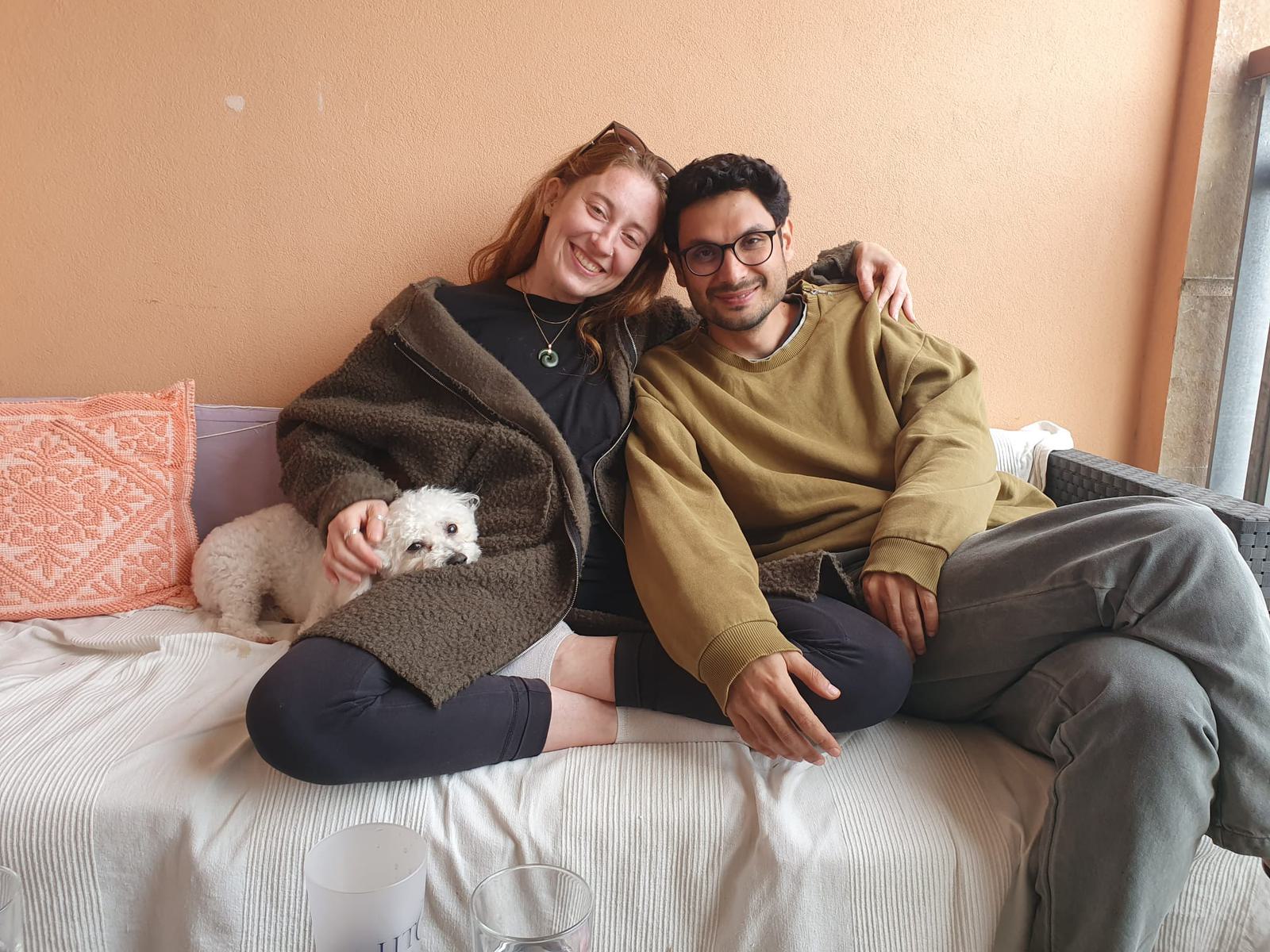 On the sofa with a small white dog